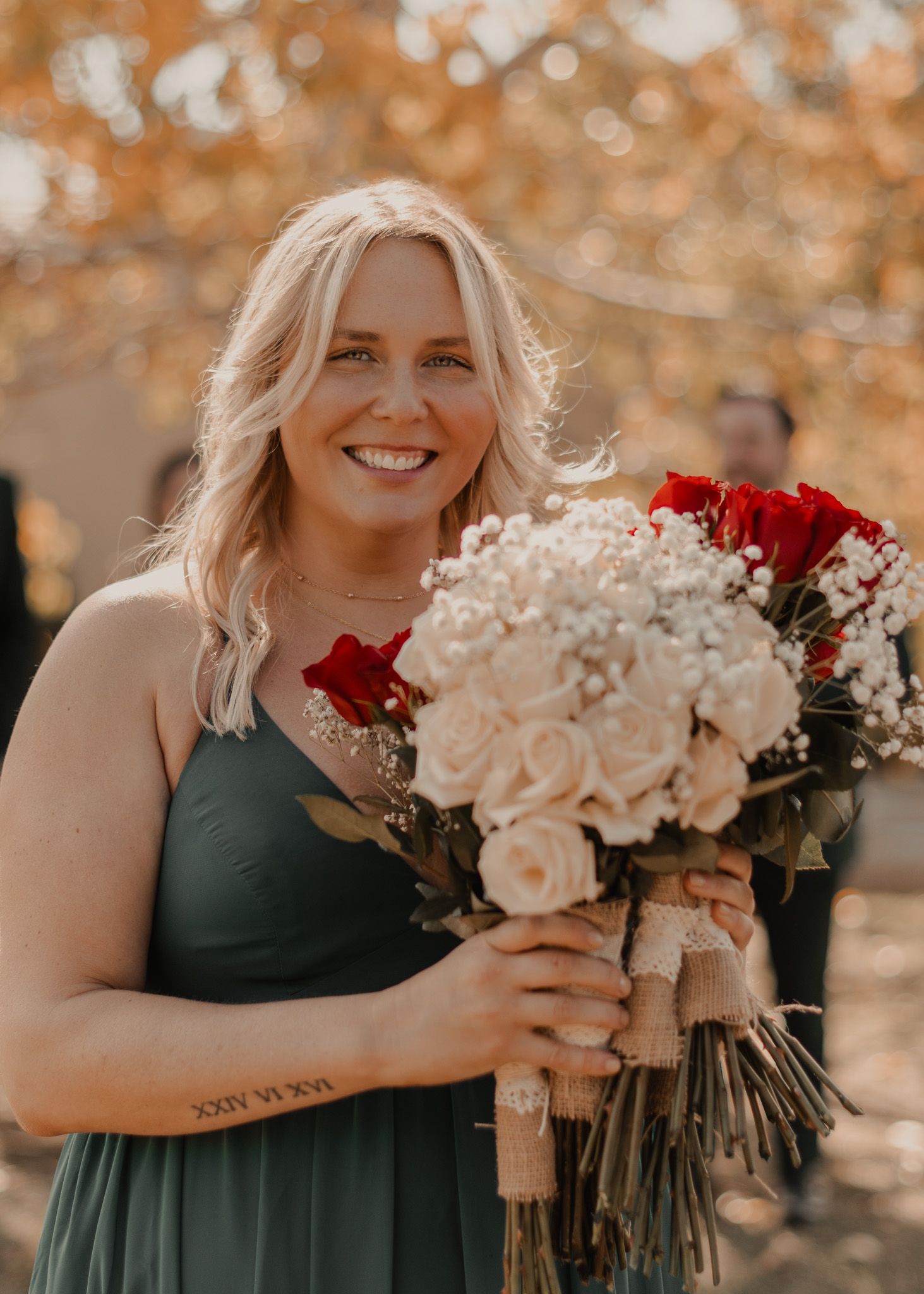 Maid of honor holding all bridal bouquets, showcasing beautiful floral arrangements.