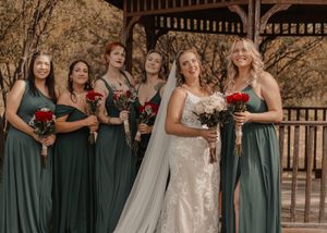 Full bridal party photo in a picturesque fall setting, showcasing vibrant autumn colors.