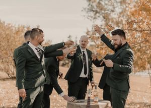 Groomsmen raising glasses for a toast, celebrating camaraderie and joy before the wedding.