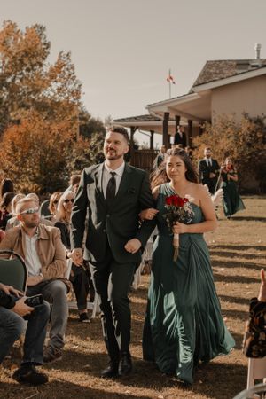 Wedding party walking down the aisle, filled with joy and excitement as they approach the altar.