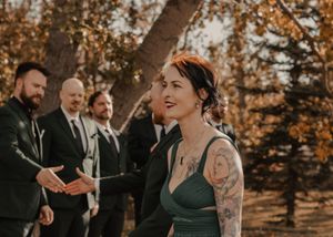 Wedding party walking down the aisle, filled with joy and excitement as they approach the altar.