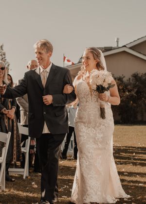 Bride and father of bride walking down the aisle, filled with joy and excitement as they approach the altar.