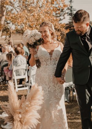 Bride and groom walking down the aisle together as a newly married couple