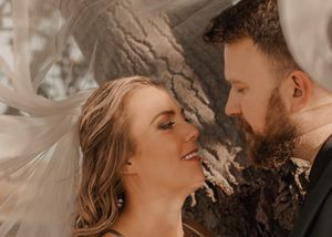 Close-up of bride and groom gazing lovingly into each other's eyes, capturing a romantic moment.
