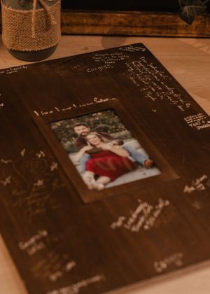 Close-up of a wedding guest book adorned with signatures, capturing heartfelt messages from attendees.