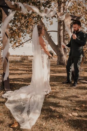 Bride and groom exchanging heartfelt vows during the wedding ceremony.