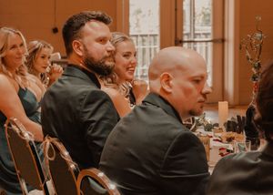 Candid shots of the bride and groom with the wedding party during speeches.