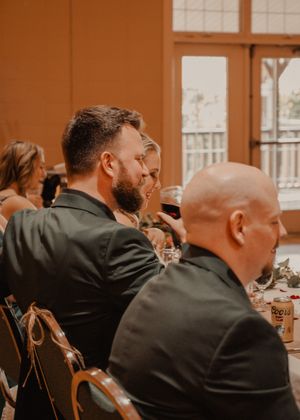 Candid shots of the bride and groom with the wedding party during speeches.