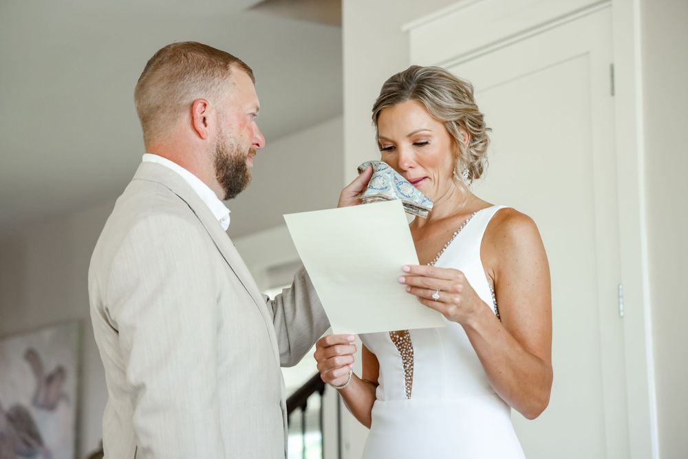 A couple shares an intimate moment while reading letters before their ceremony.