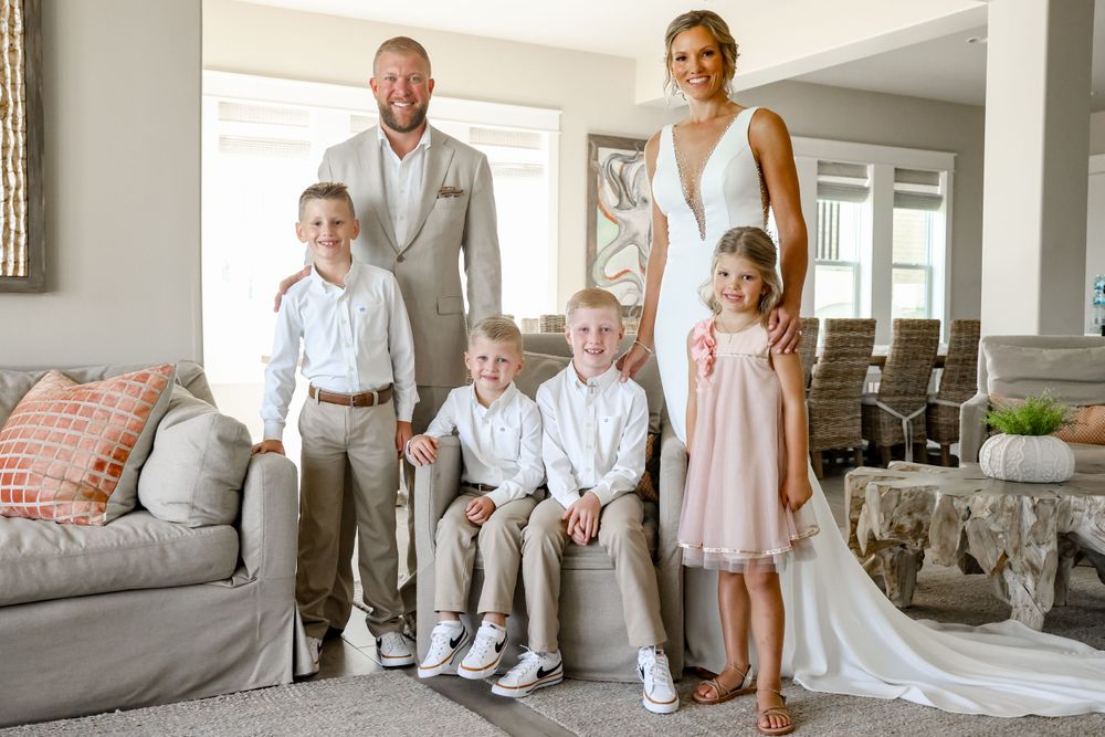 A family portrait captures a joyful moment in an elegantly decorated living room.