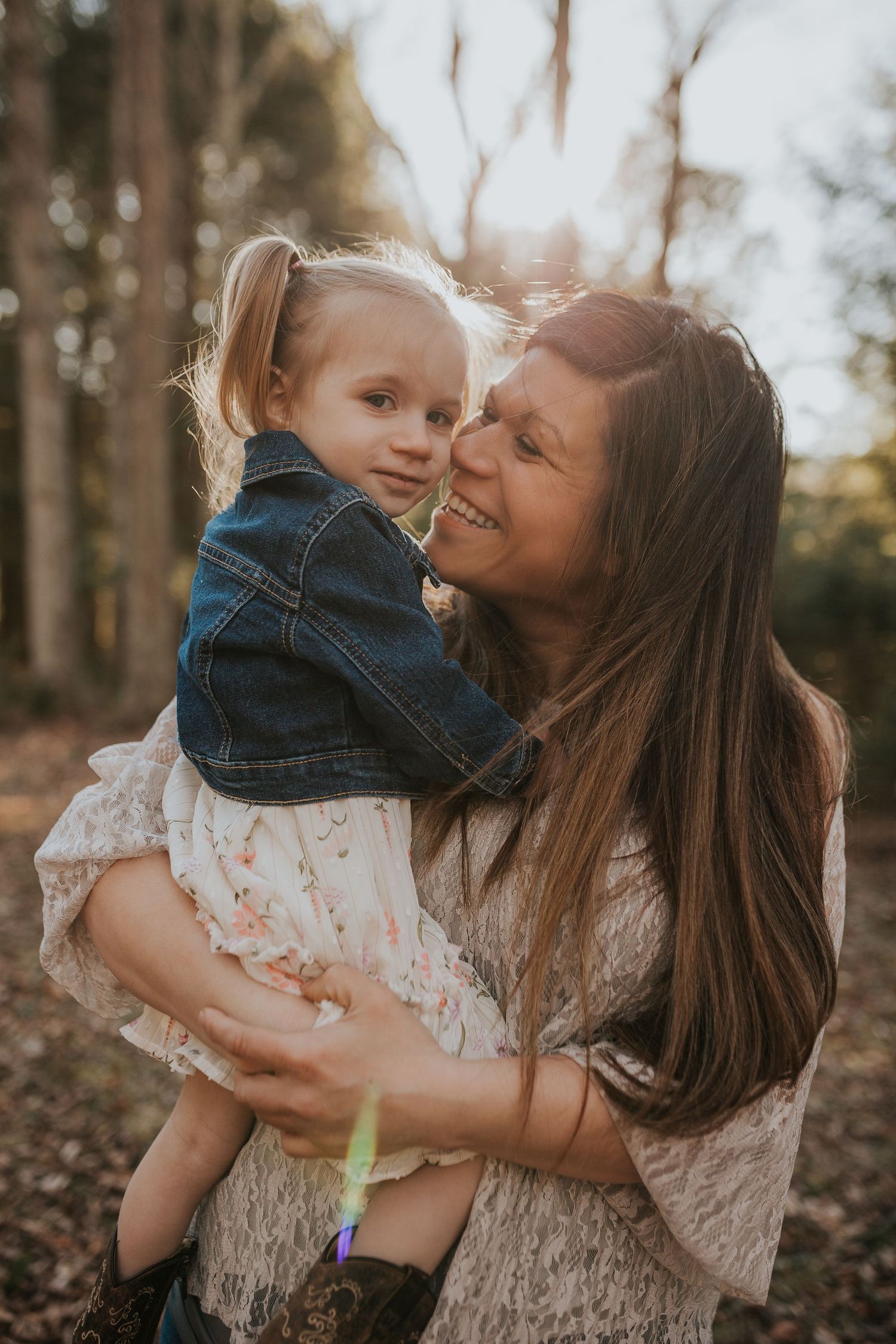 Sweet tender moment between parent and child in autumn forest setting.