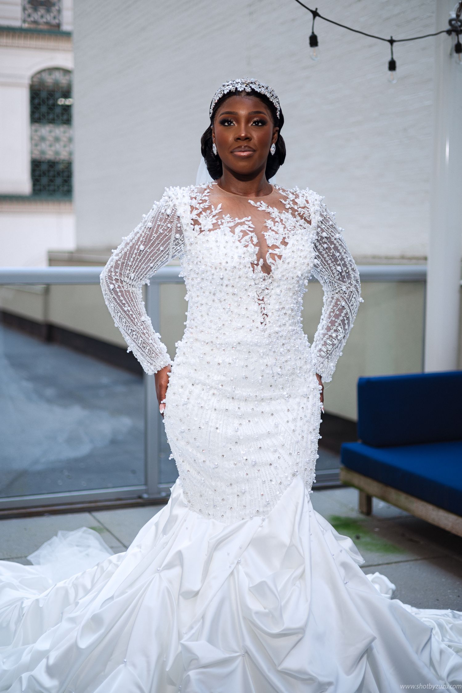 Stunning mermaid wedding gown with intricate lace sleeves and beaded details features a dramatic ruffled train.