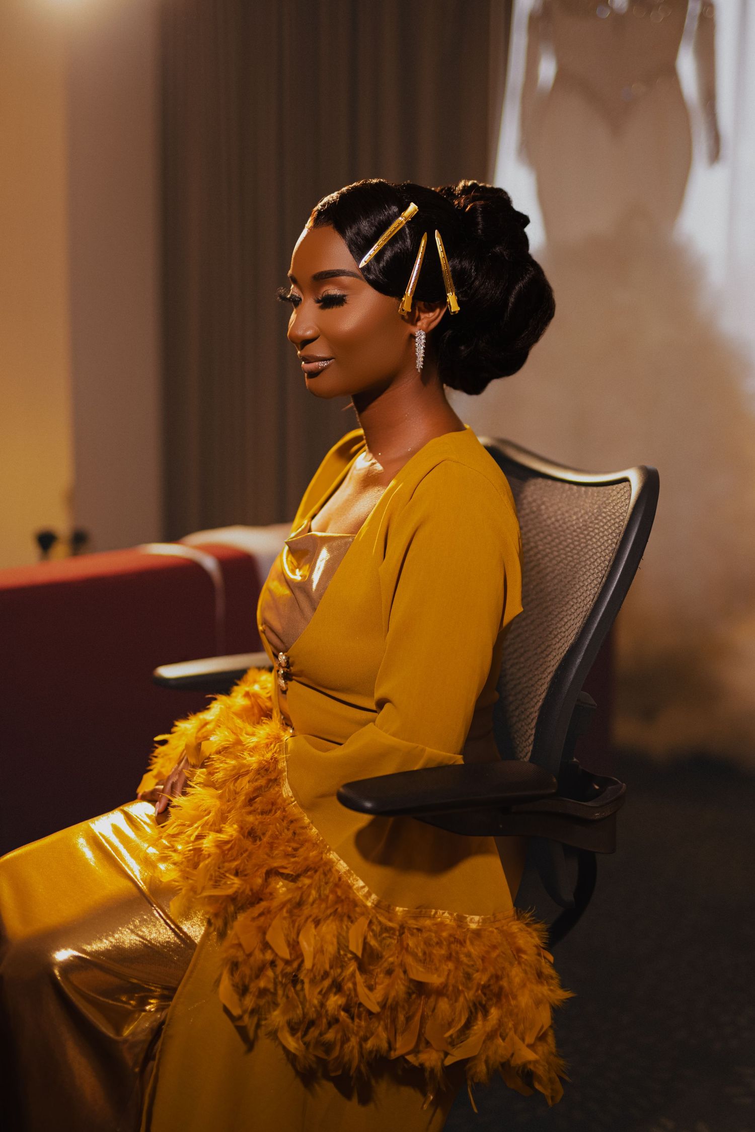 Elegant bride in mustard yellow formal dress with ornate hair accessories.