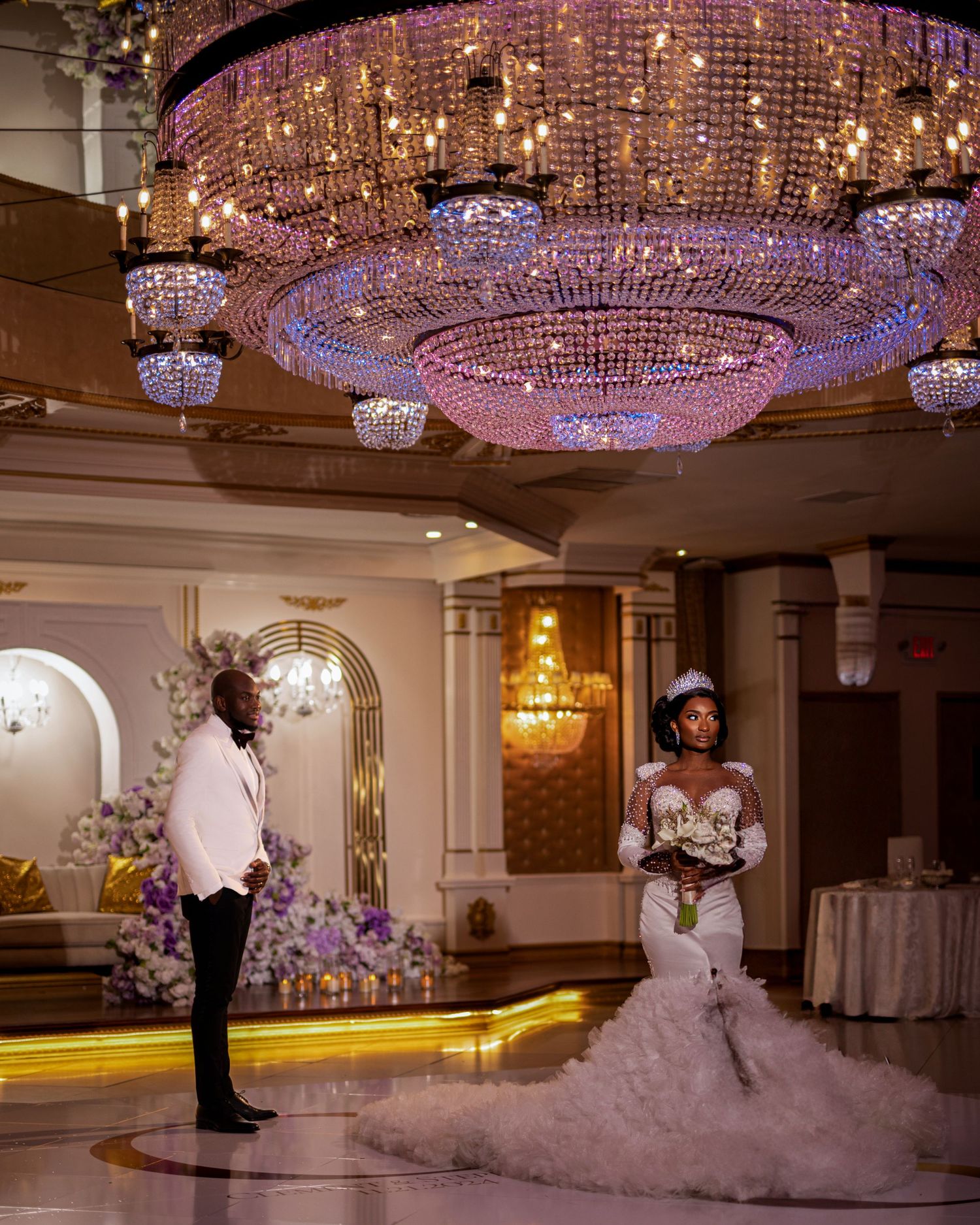 Elegant wedding venue features stunning crystal chandeliers and ornate decor for a luxurious celebration.