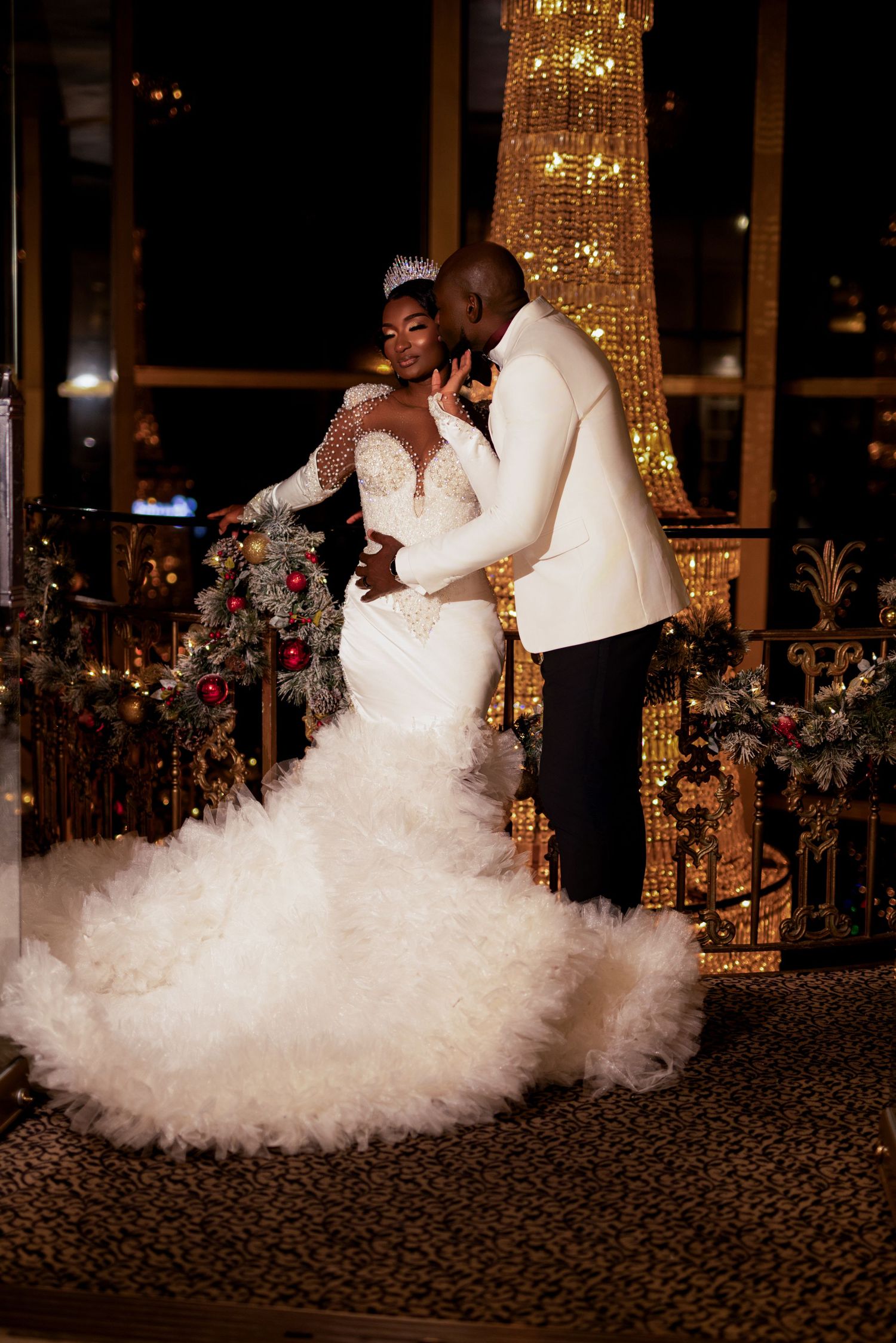 Romantic evening wedding photo under illuminated decor and spectacular mermaid-style gown.