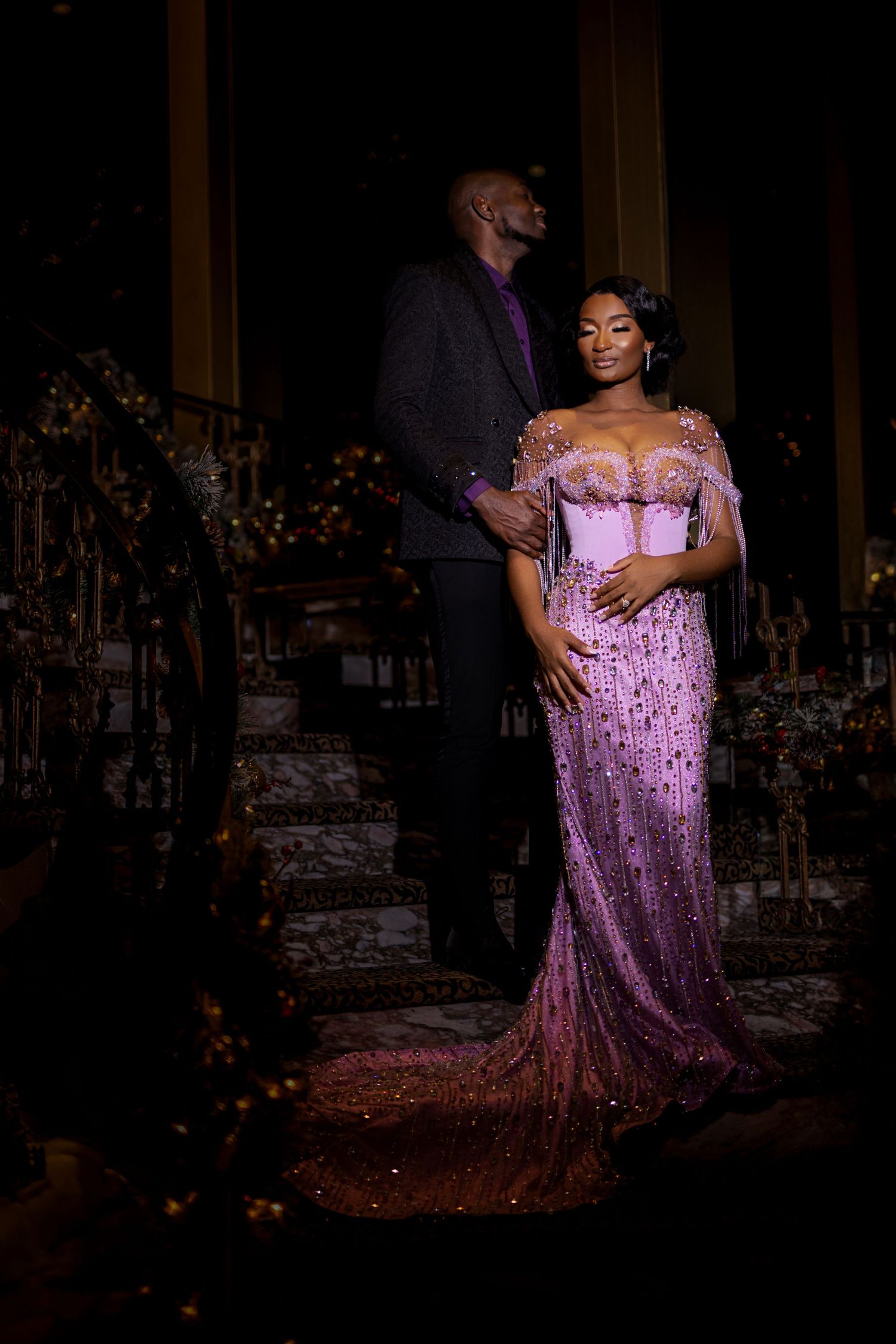 Glamorous evening portrait featuring stunning beaded pink gown with dramatic lighting effects.
