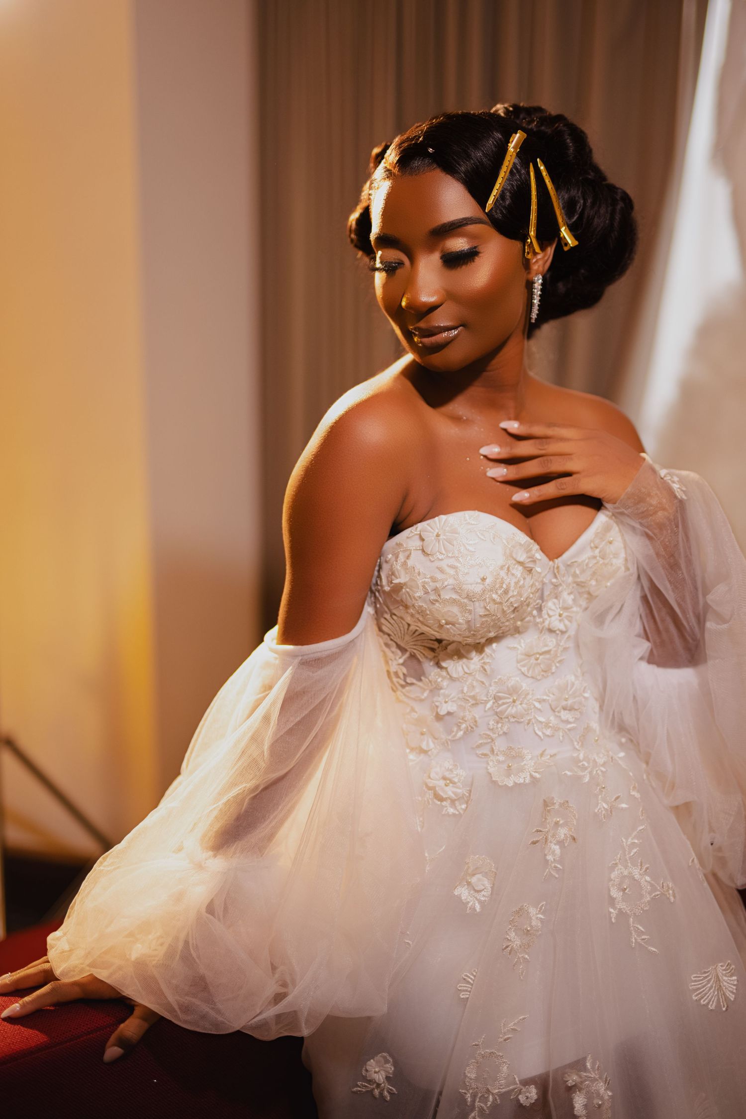 Elegant bridal portrait featuring detailed lace gown and ornate hair accessories.