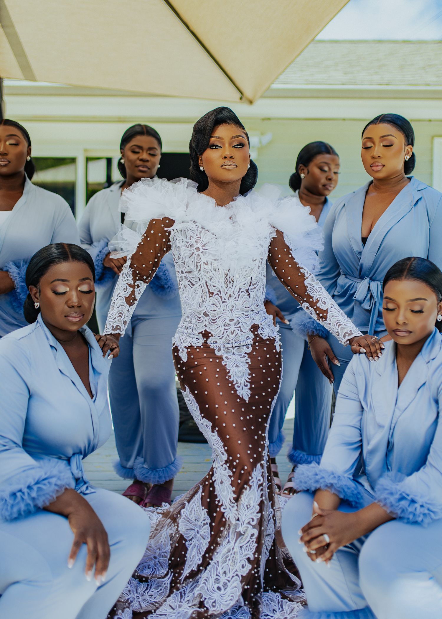 Bridesmaids in matching light blue dresses dance and celebrate at a wedding reception.