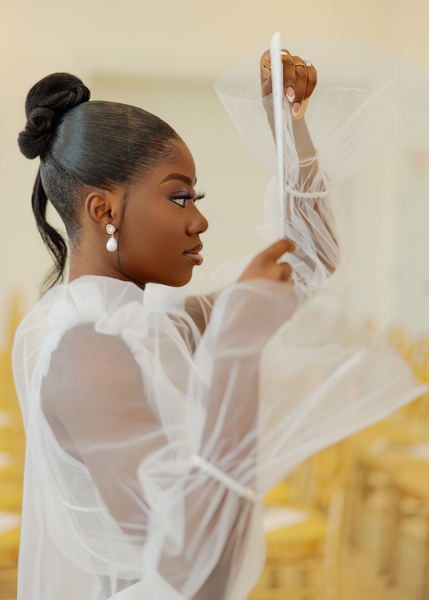 Elegant bridal preparation photos showing white silk robe details in golden light.