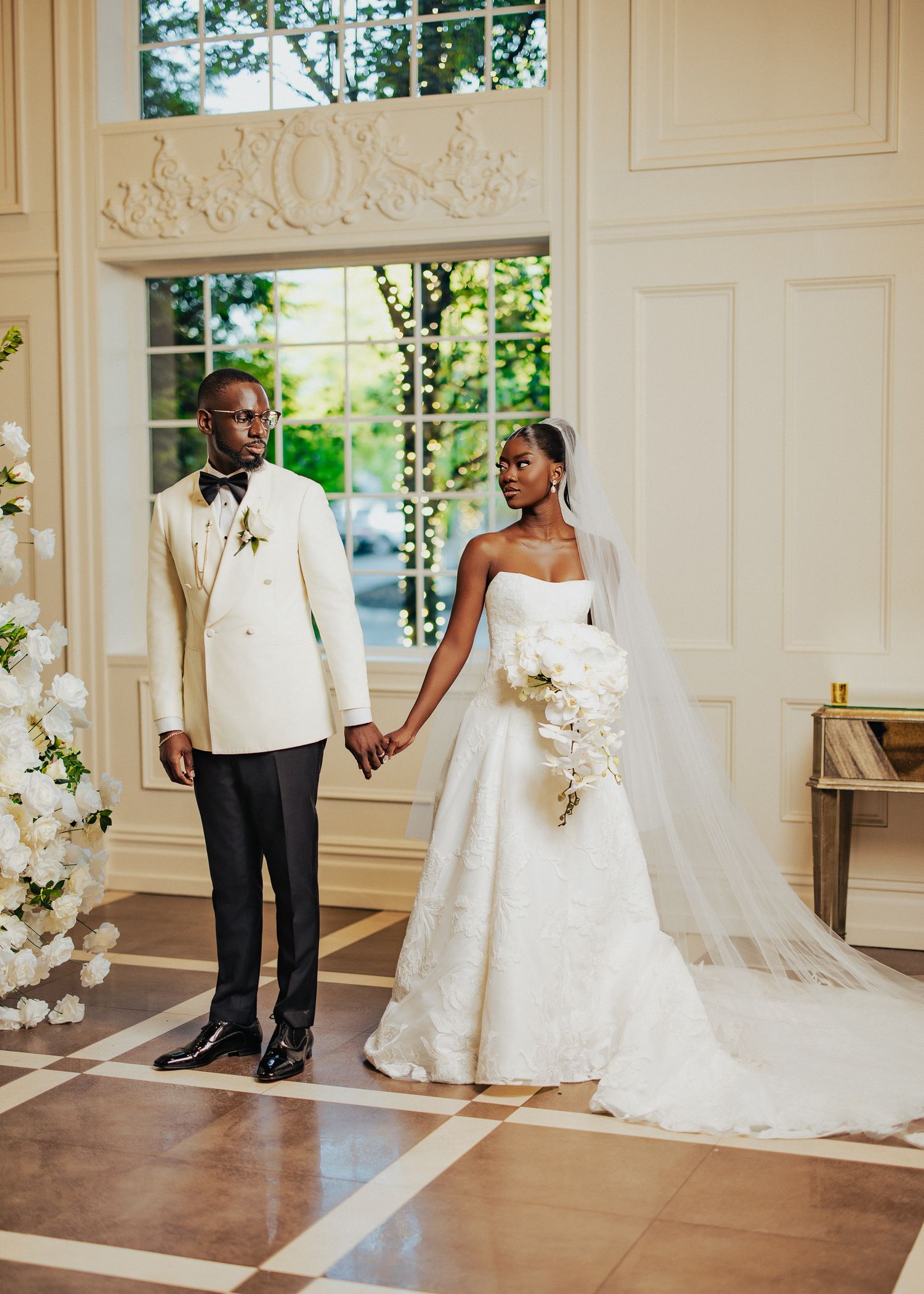 Elegant wedding venue photos showing white decor and architectural details.
