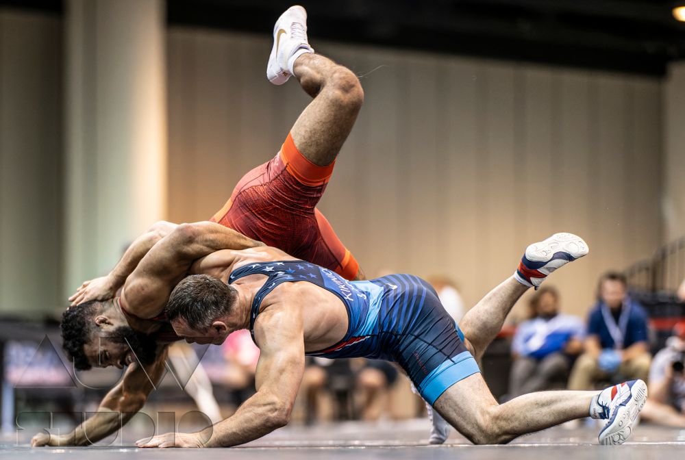 Two wrestlers engaged in intense ground combat during a competitive match.