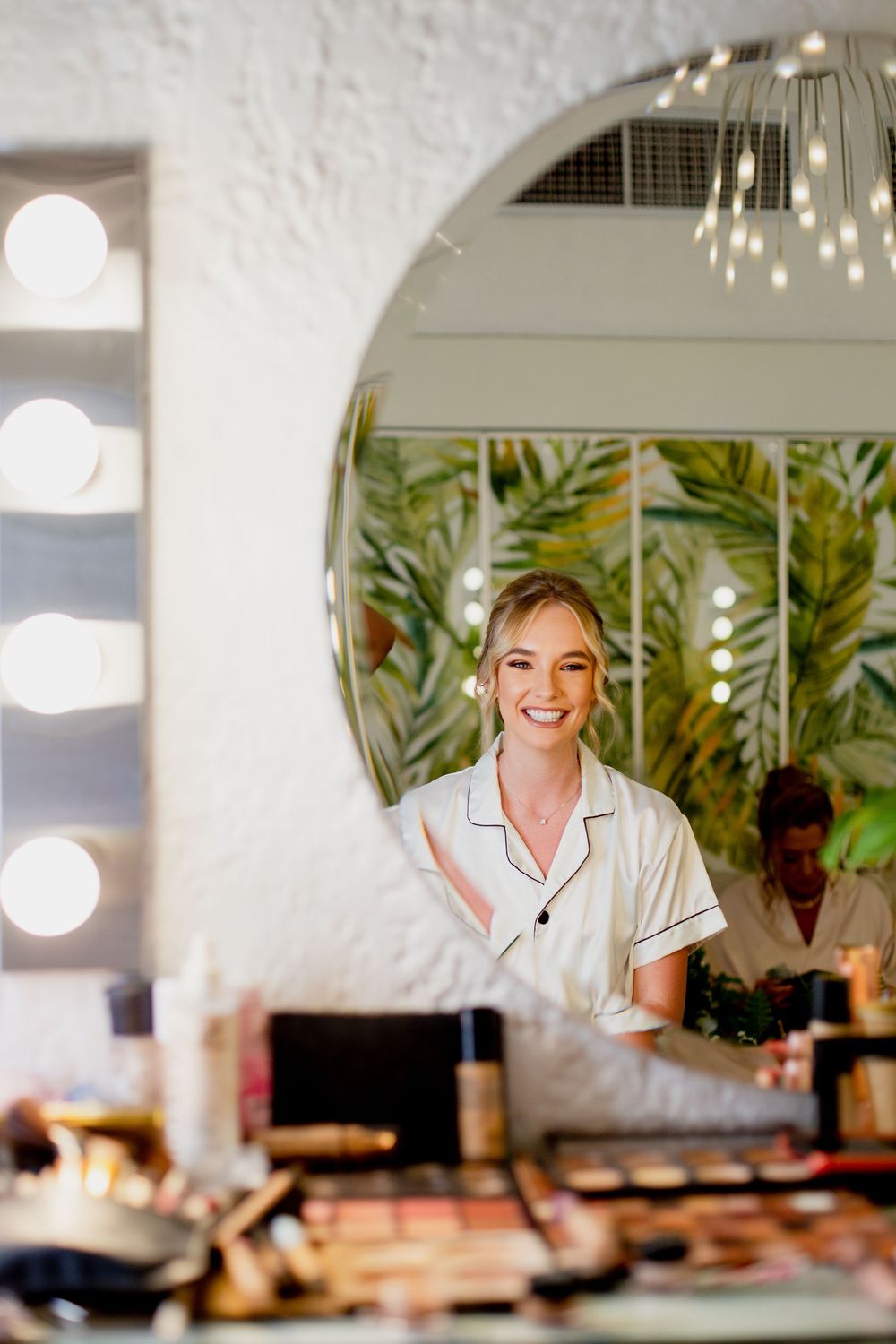 A series of four connected photos showing a person in white against a bright interior space with plants and warm lighting.