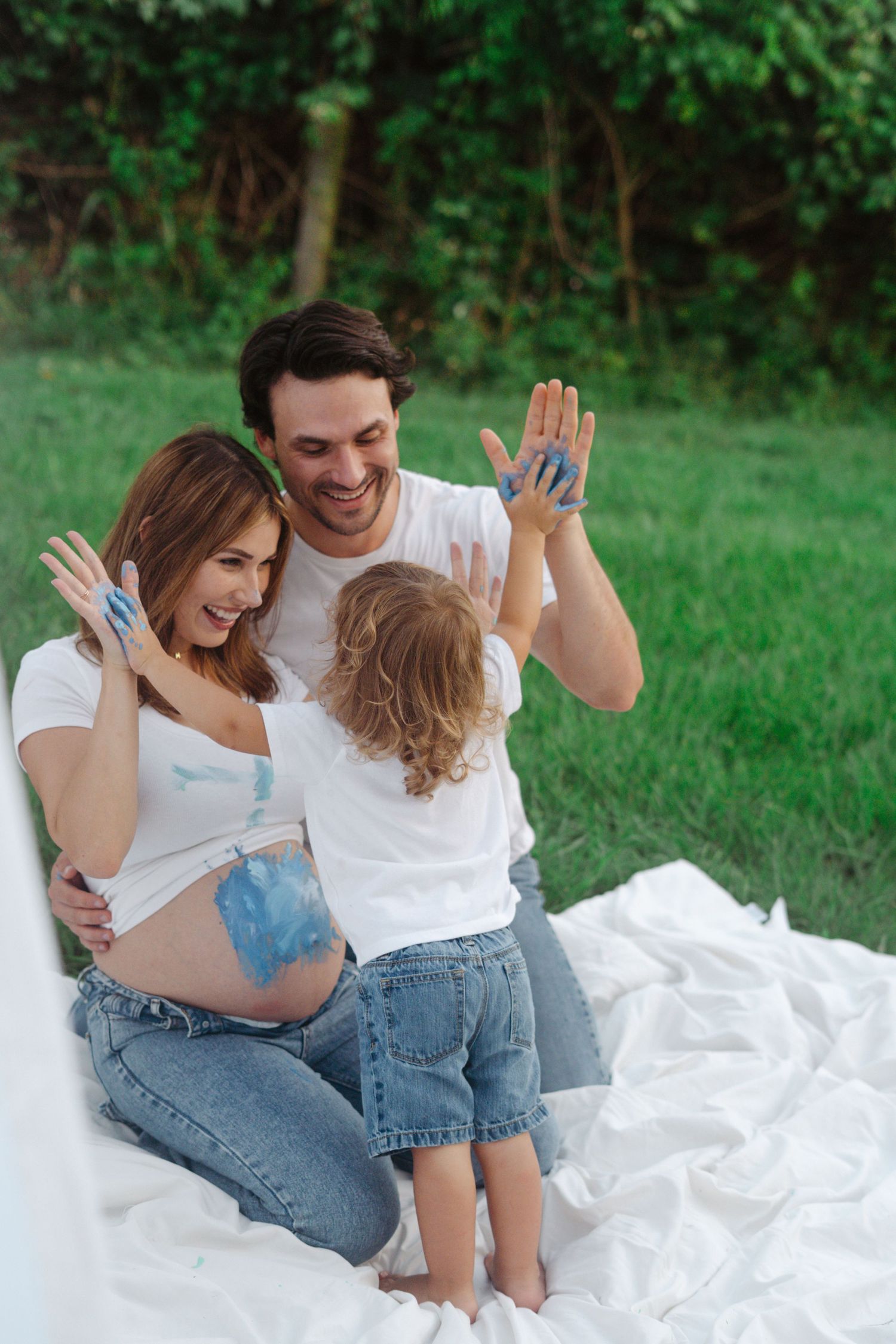 Maternity session outdoors with siblings, playful paint, colorful family photos, natural light, candid moments, lifestyle photography.