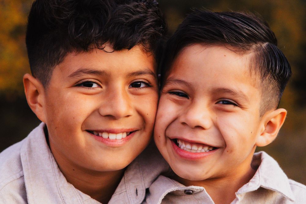 Close up portrait of two people smiling warmly at the camera.