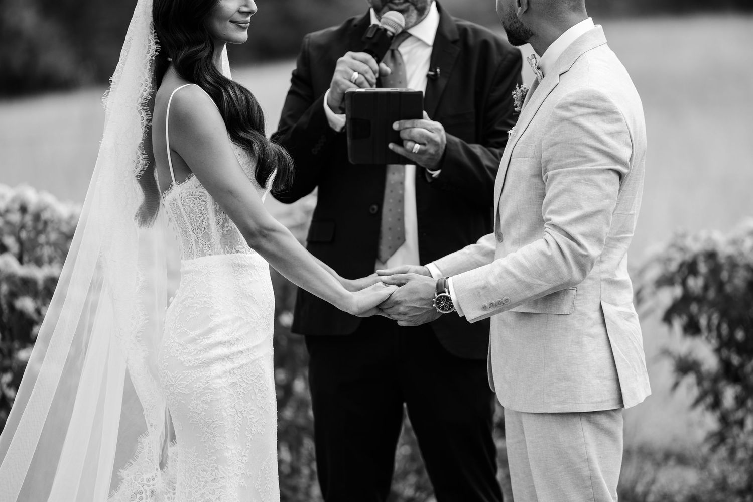 A black and white photo series showing a couple sharing intimate moments during their outdoor wedding ceremony.