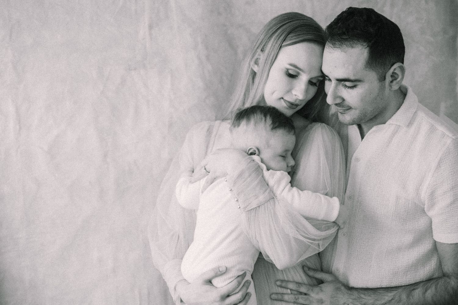 Intimate black and white portrait series showing tender moments.