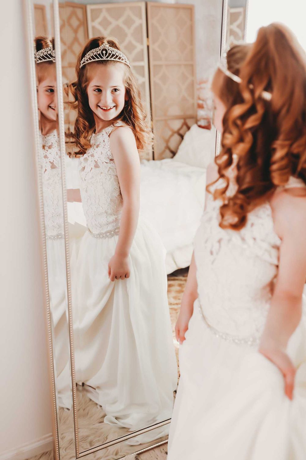 Portrait reflection in triple mirror panel with warm lighting.
