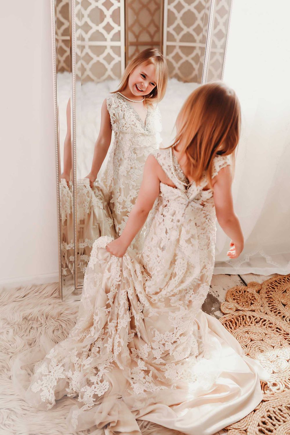 A joyful moment captured in mirrors as someone twirls in a flowing lace wedding dress.