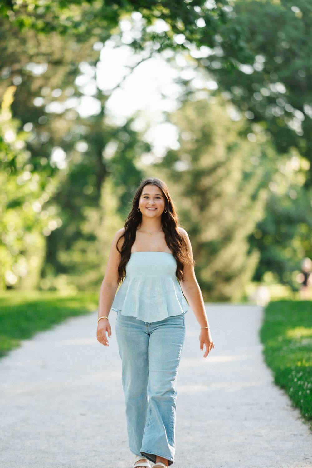 A series of photos showing someone walking on a gravel path surrounded by lush greenery on a sunny day.
