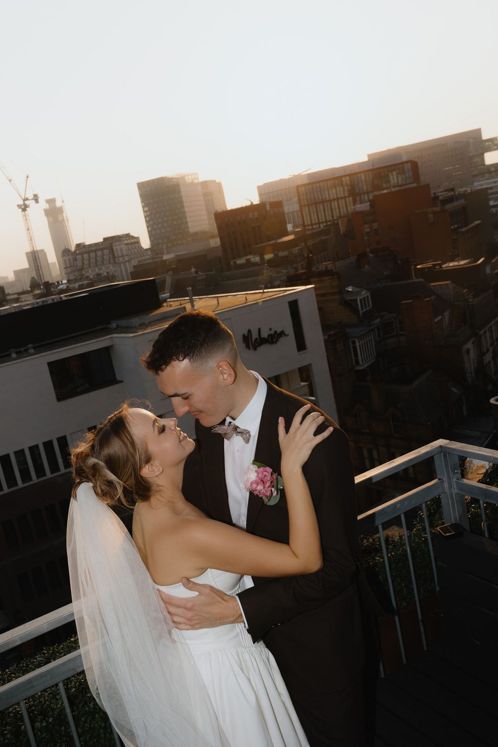 A romantic sunset rooftop wedding moment captured in a series of intimate photographs.