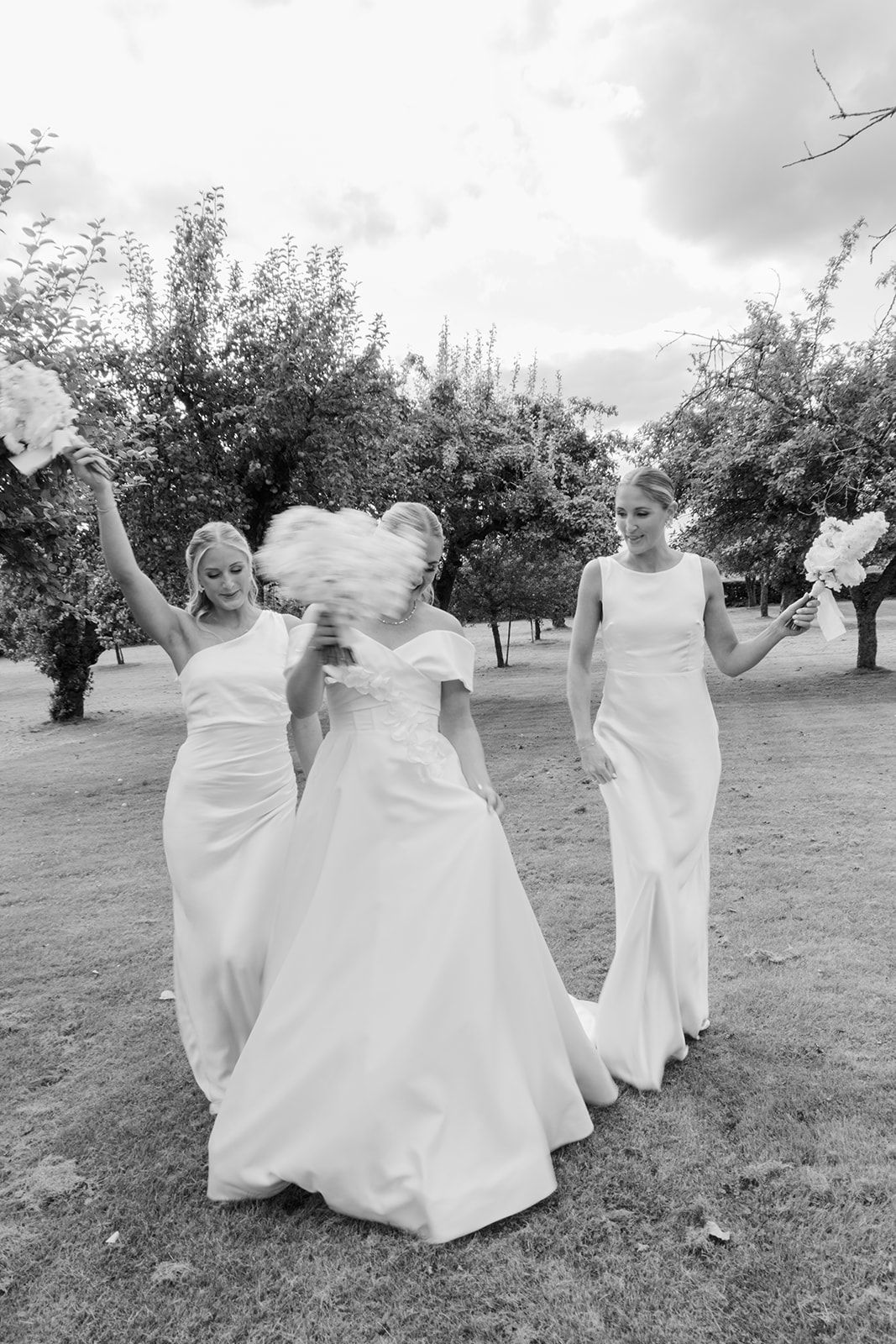 Black and white sequence of candid wedding moments showing joyful reactions and laughter during an outdoor celebration.