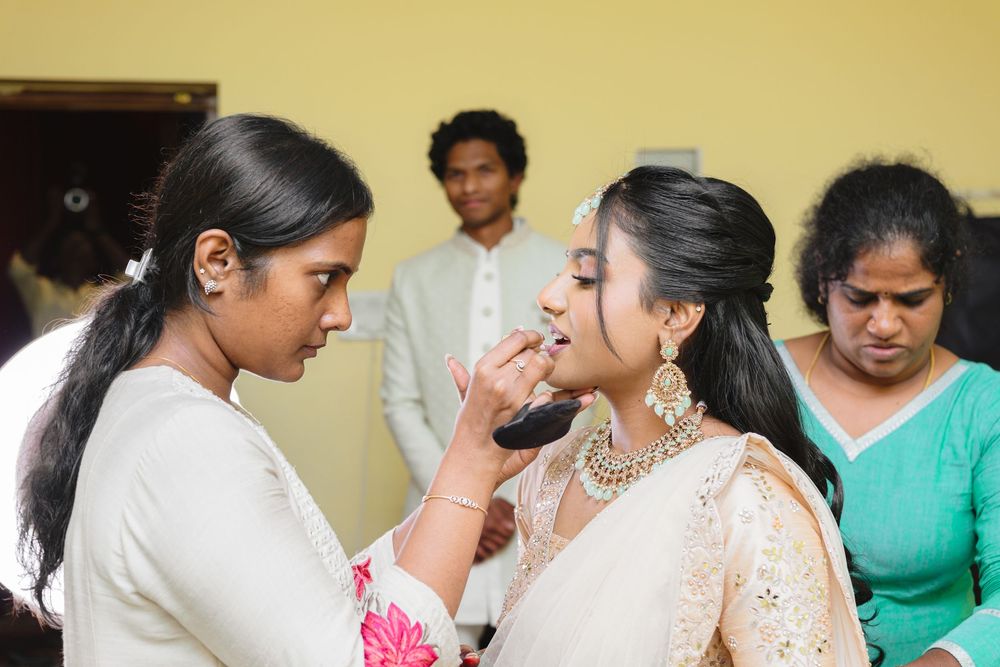 Traditional wedding ceremony participants interact in a beautifully decorated indoor setting.
