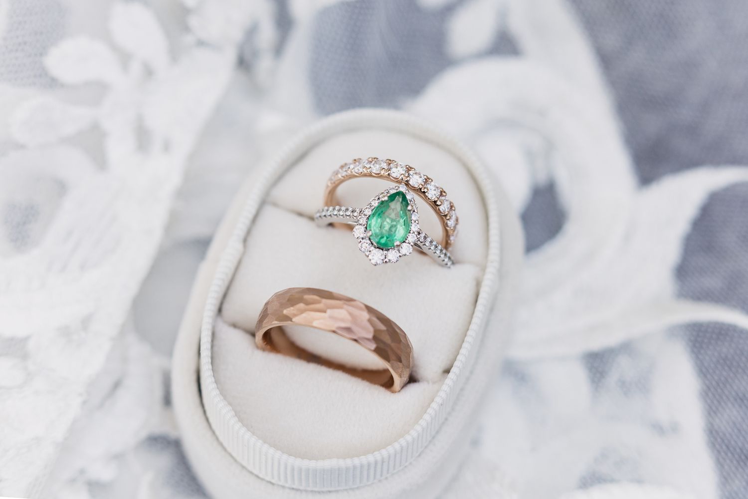 Delicate engagement rings with diamonds and gemstones displayed on white soft fabric background. Duluth Superior Wedding Photography