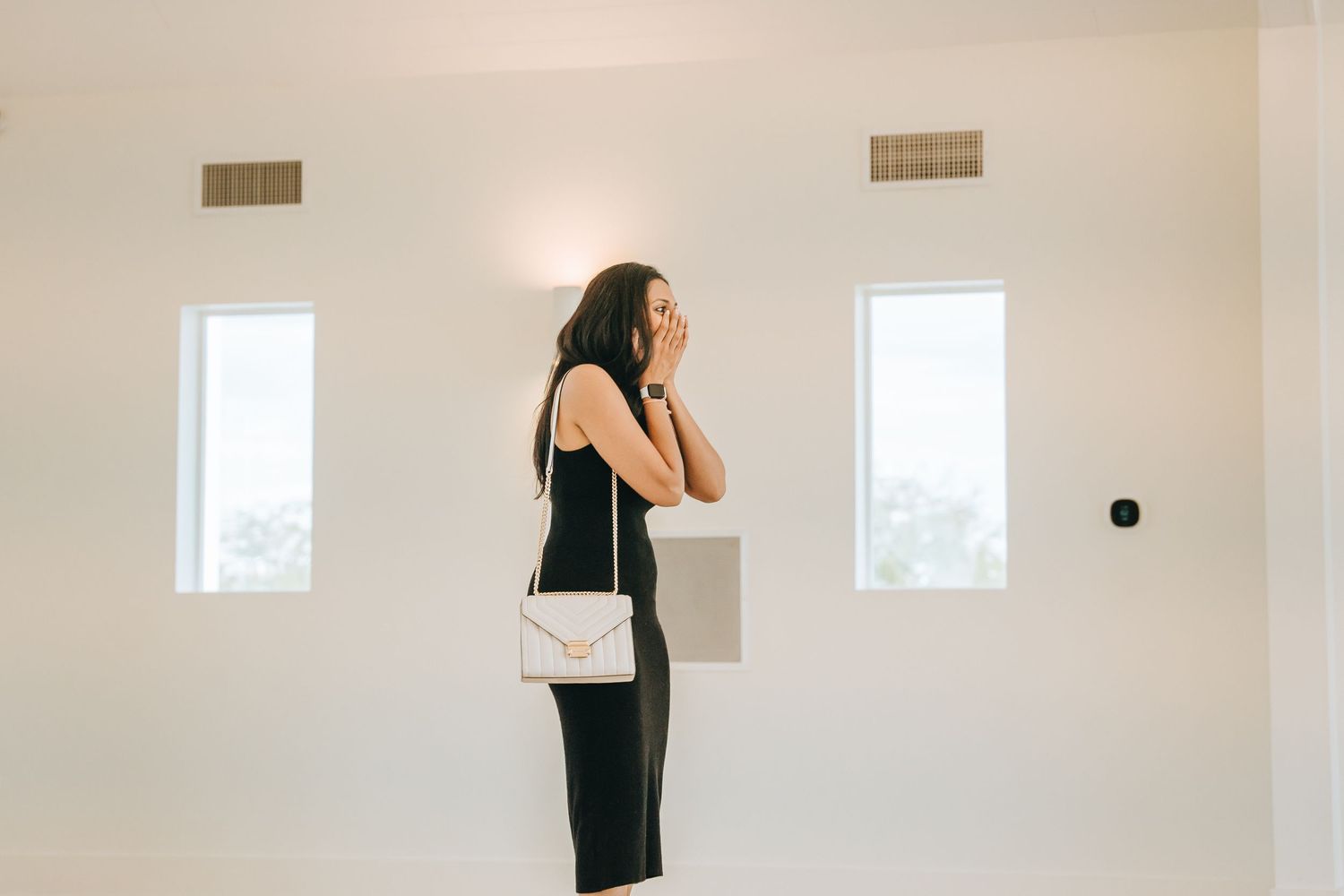 Interior of a modern white chapel with large windows and minimal decor.