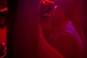 Abstract red and purple lighting creates a moody atmospheric effect in a dimly lit space.