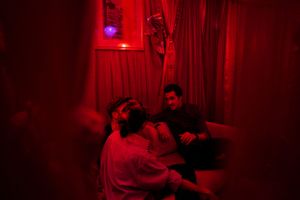 Cozy lounge area illuminated by dramatic red lighting and ambient decor.