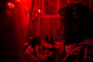 Blurry silhouette in deep red lighting creating mysterious atmosphere.
