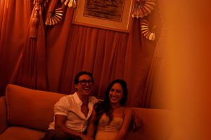 Cozy seating area bathed in warm orange lighting with decorative wall elements.