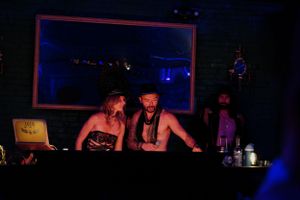 DJ booth illuminated by blue lights in a nightclub setting.
