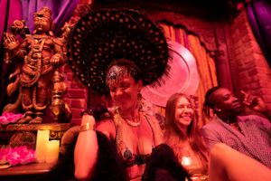 Lively nightclub scene with decorative lighting and partygoers enjoying the atmosphere.