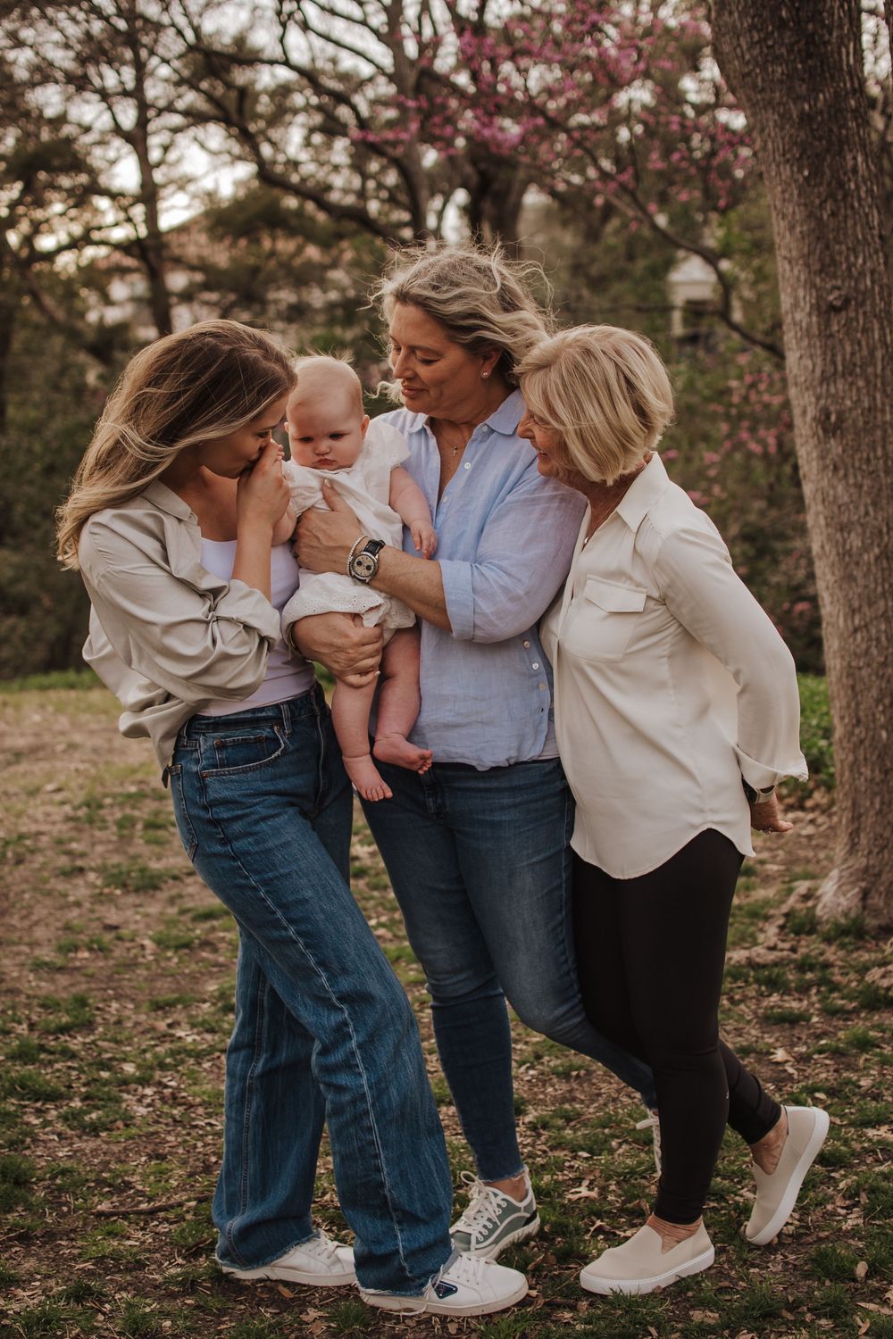Three generations share a joyful outdoor moment together with a baby. Dallas Texas