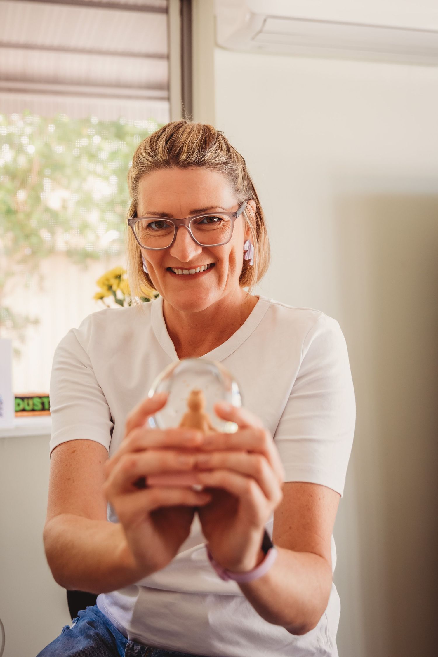 Woman in white t-shirt and glasses with expressive facial expressions shown in sequence using mobile phone.