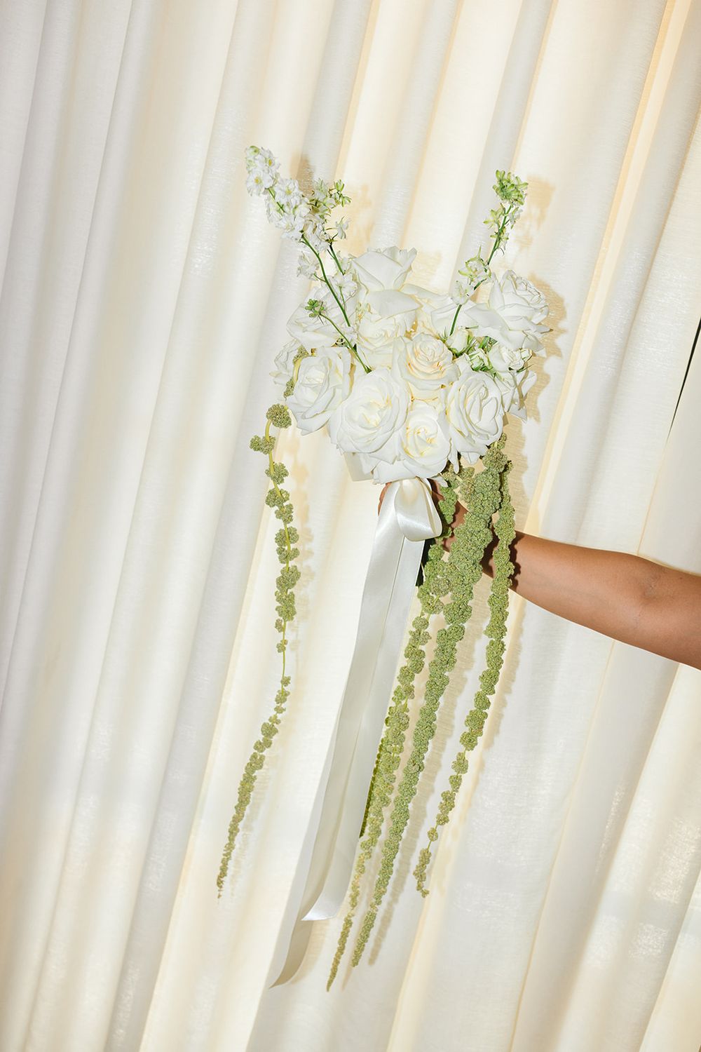 Delicate white flowing curtains with cascading green floral vines create an ethereal window display.