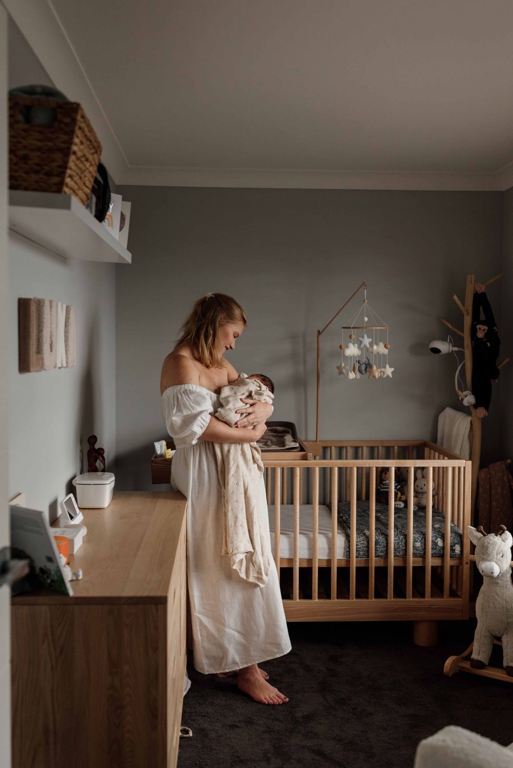 Mother and baby in nursery during in-home newborn session in Sydney’s Hills District.