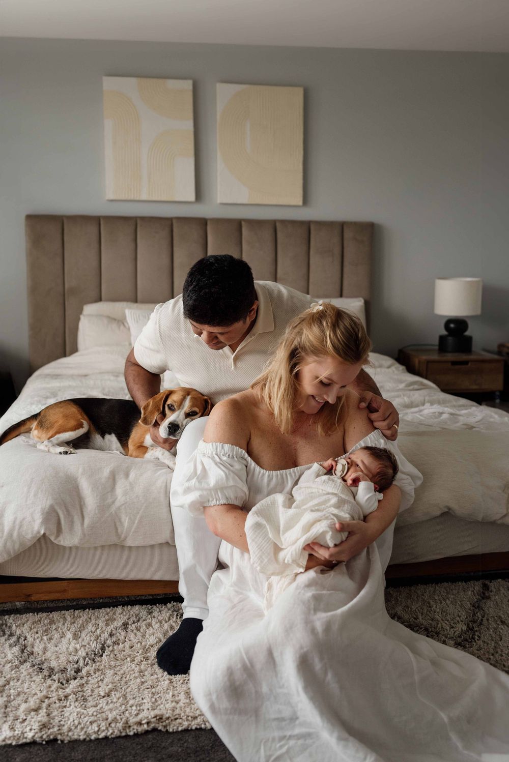 Relaxed family in home newborn photoshoot with dog, Sydney Australia.