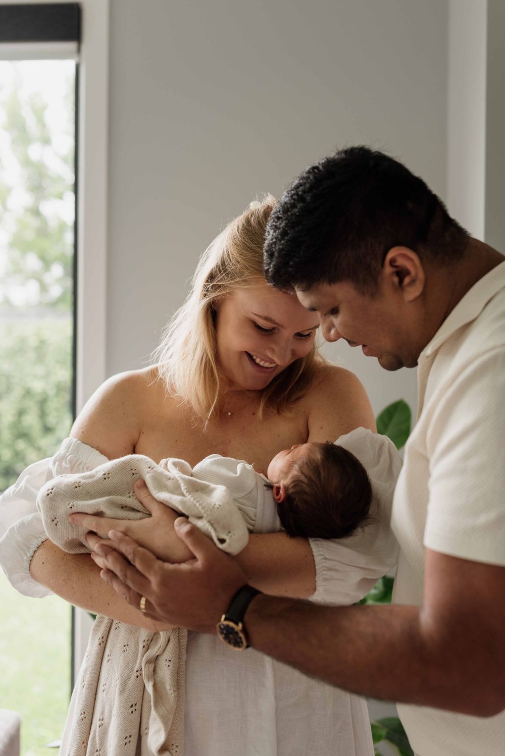 Parents loving on baby during photoshoot at home in Sydney.